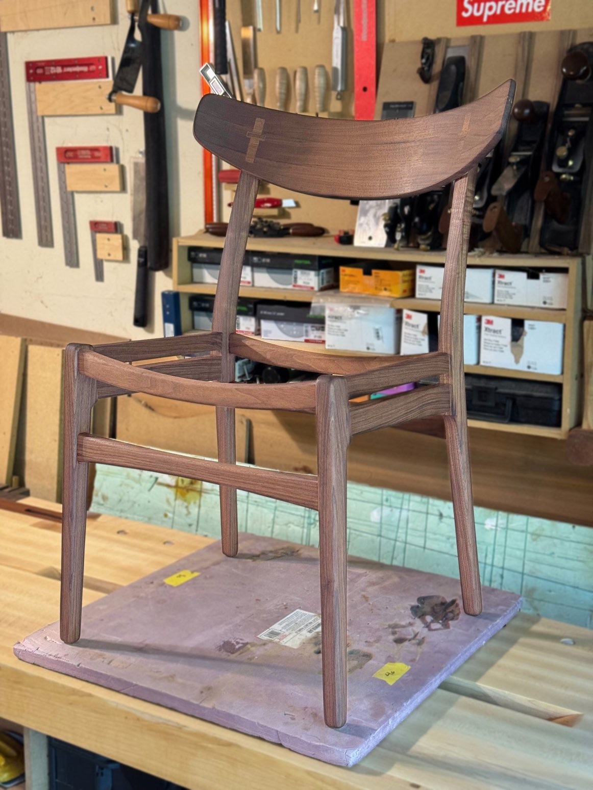 Handmade walnut dining chair in workshop